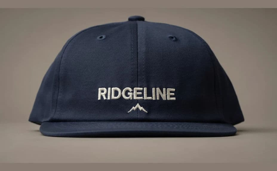 Cap mockup with cream thread embroidery on a dark panel