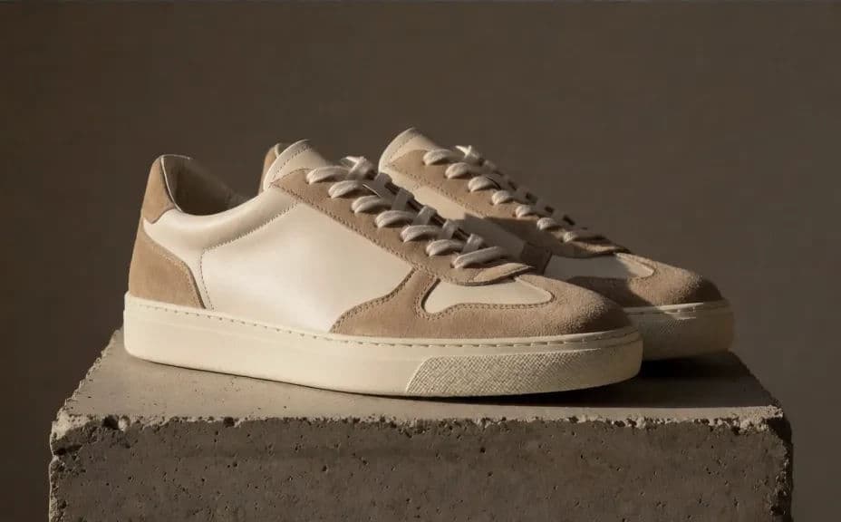 Pair of trainers photographed from a three-quarter angle on a textured concrete surface