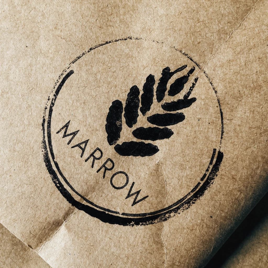 Rubber-stamped mark on kraft paper with uneven ink coverage, generated with Recraft