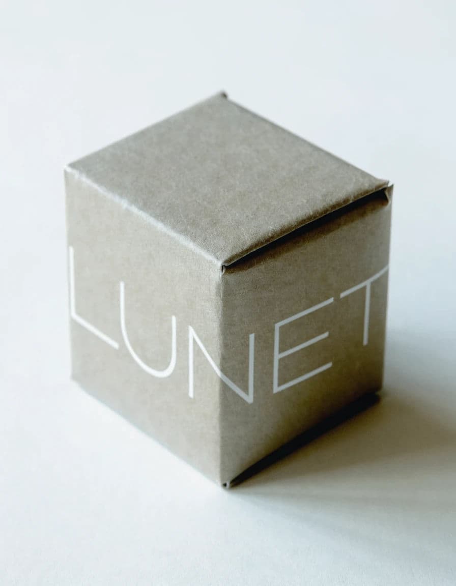Logo applied to a folded carton with the mark following the fold, generated with Recraft