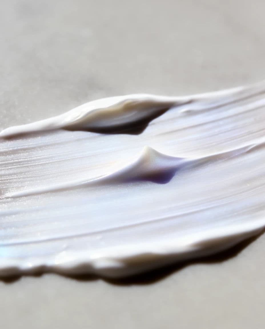 Macro of a cream swatch showing peaks, drag marks and a slight sheen, generated with Krea 2 Large