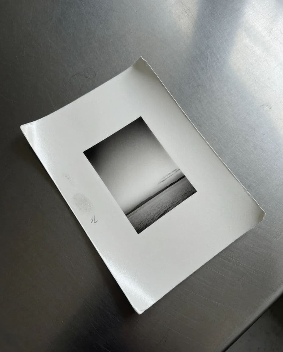 Black and white darkroom print with white borders resting on a table, generated with Krea 2 Medium
