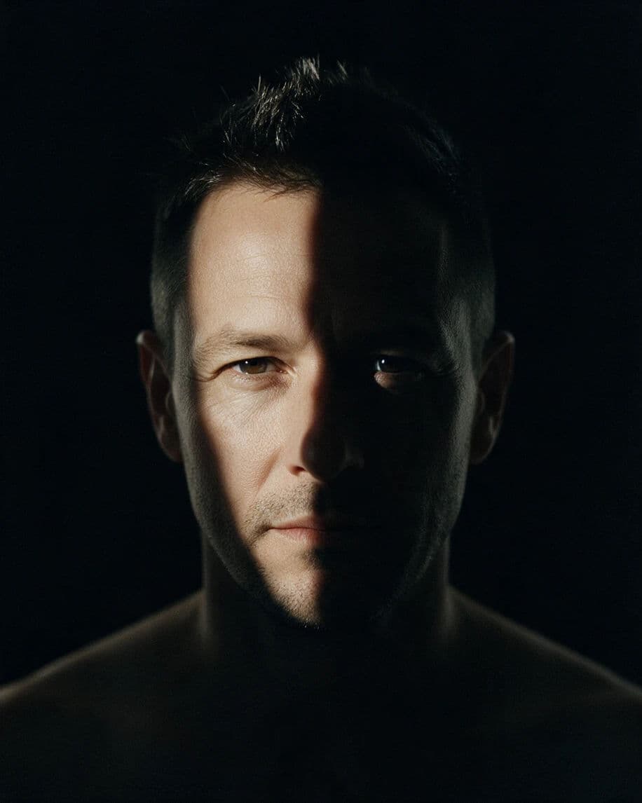 Portrait split precisely down the middle by a hard side light, generated with Seedream 5.0 Pro