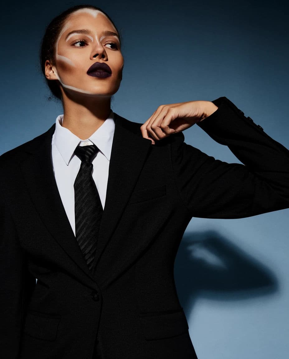 Studio fashion portrait against seamless paper with one hard light and a crisp shadow, generated with Krea 2 Large