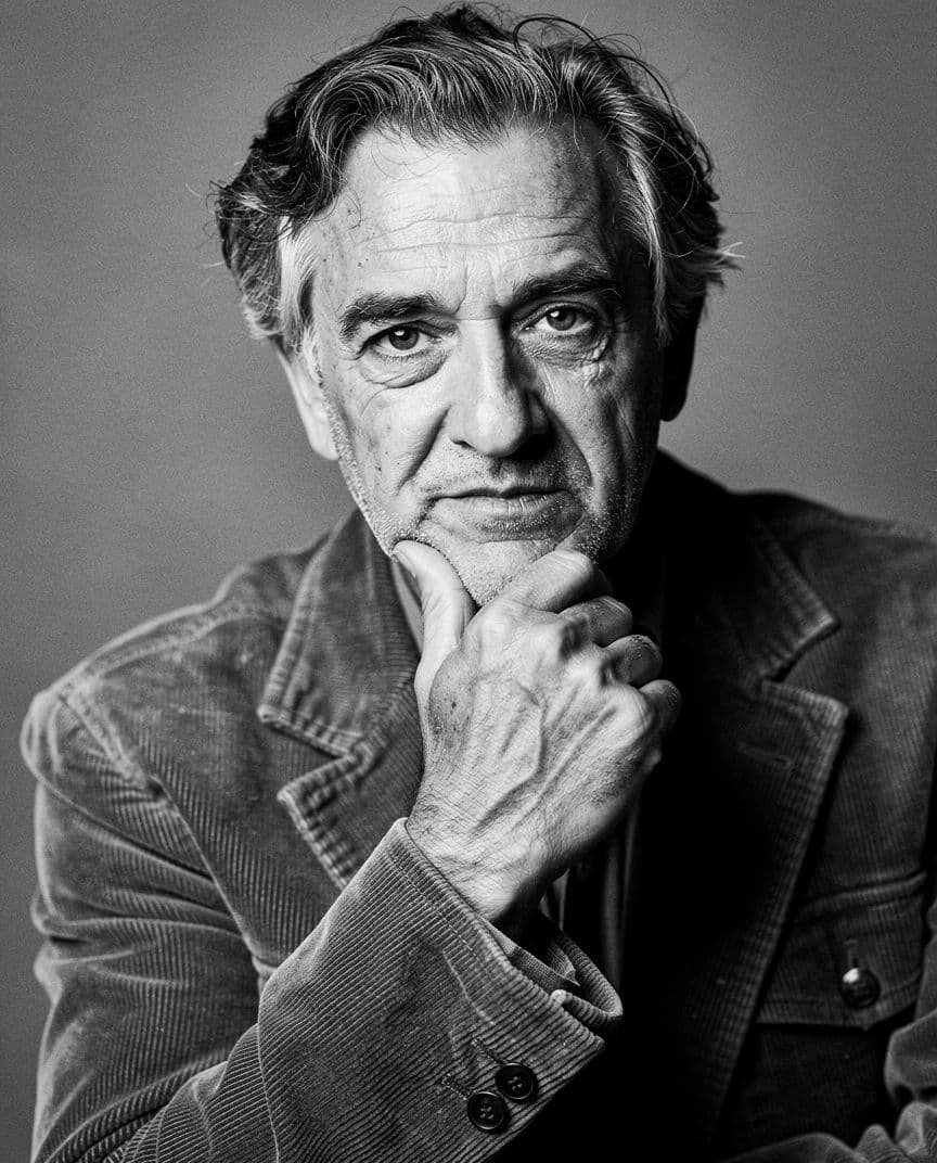 Author headshot in black and white with strong texture and a plain background, generated with Flux 2 Pro