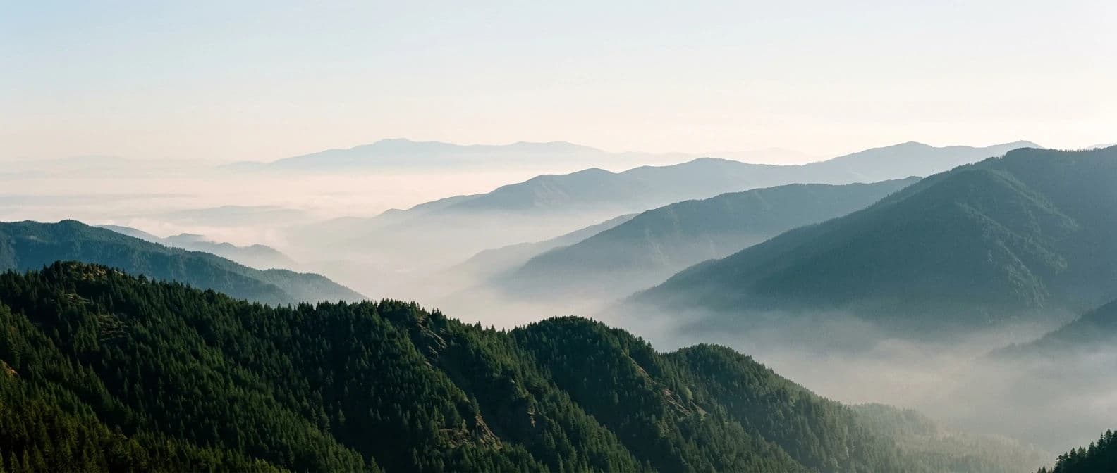 Wide panoramic landscape photograph of four receding mountain ridgelines each paler and cooler than the one in front, generated with Nano Banana 2