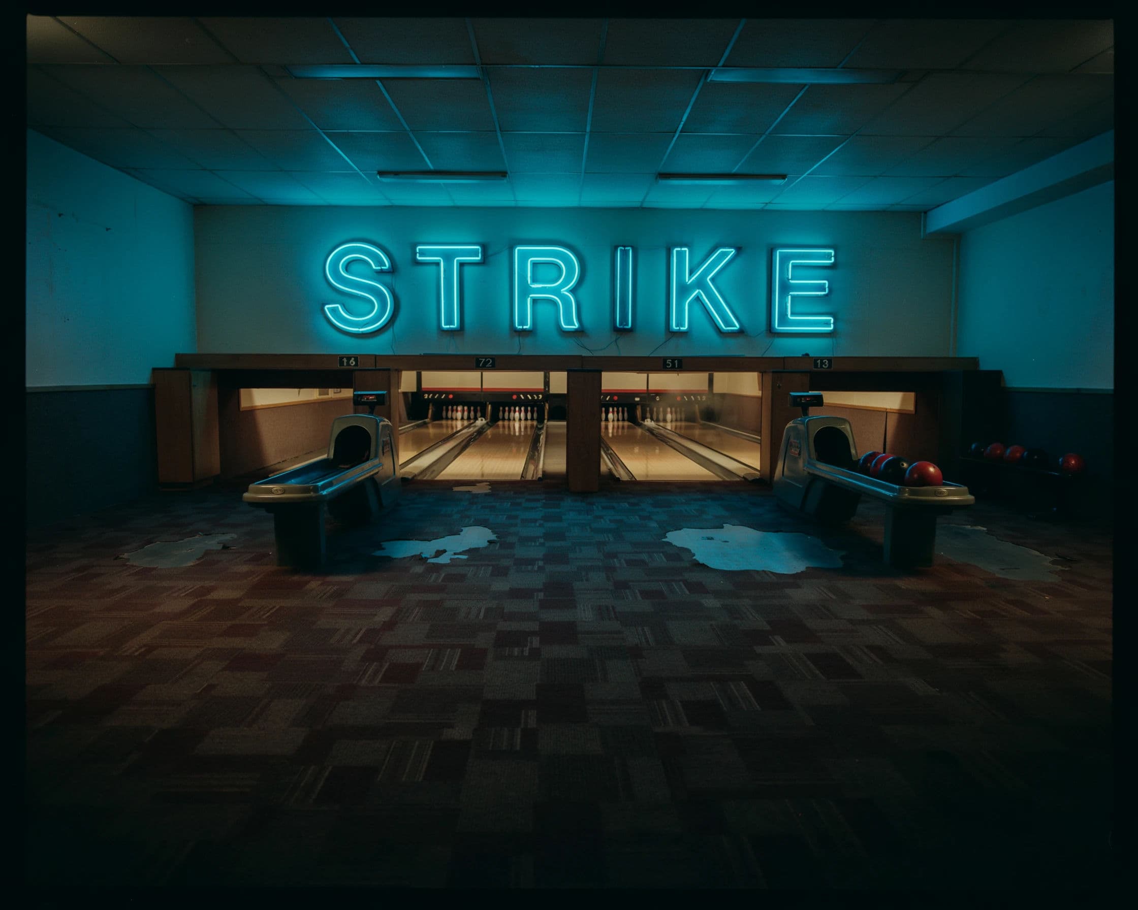 Photograph of a bowling alley concourse lit by a STRIKE sign over the lanes, generated with Ideogram 4.0