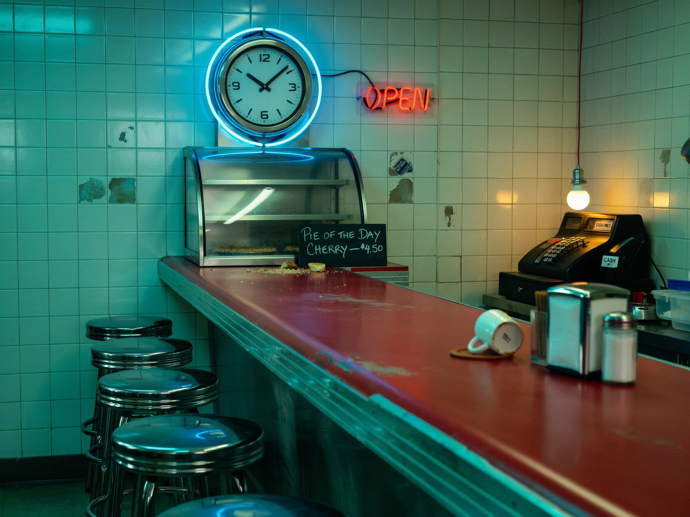 Photograph of a diner counter lit by a neon ring around a wall clock, generated with Ideogram 4.0
