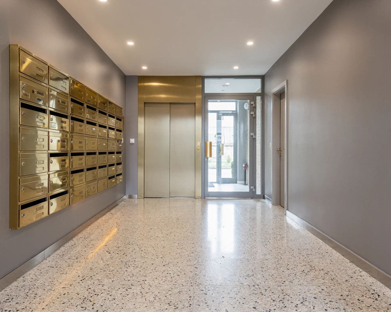 Listing photograph of a communal entrance lobby with post boxes and a lift, generated with Flux 2 Pro