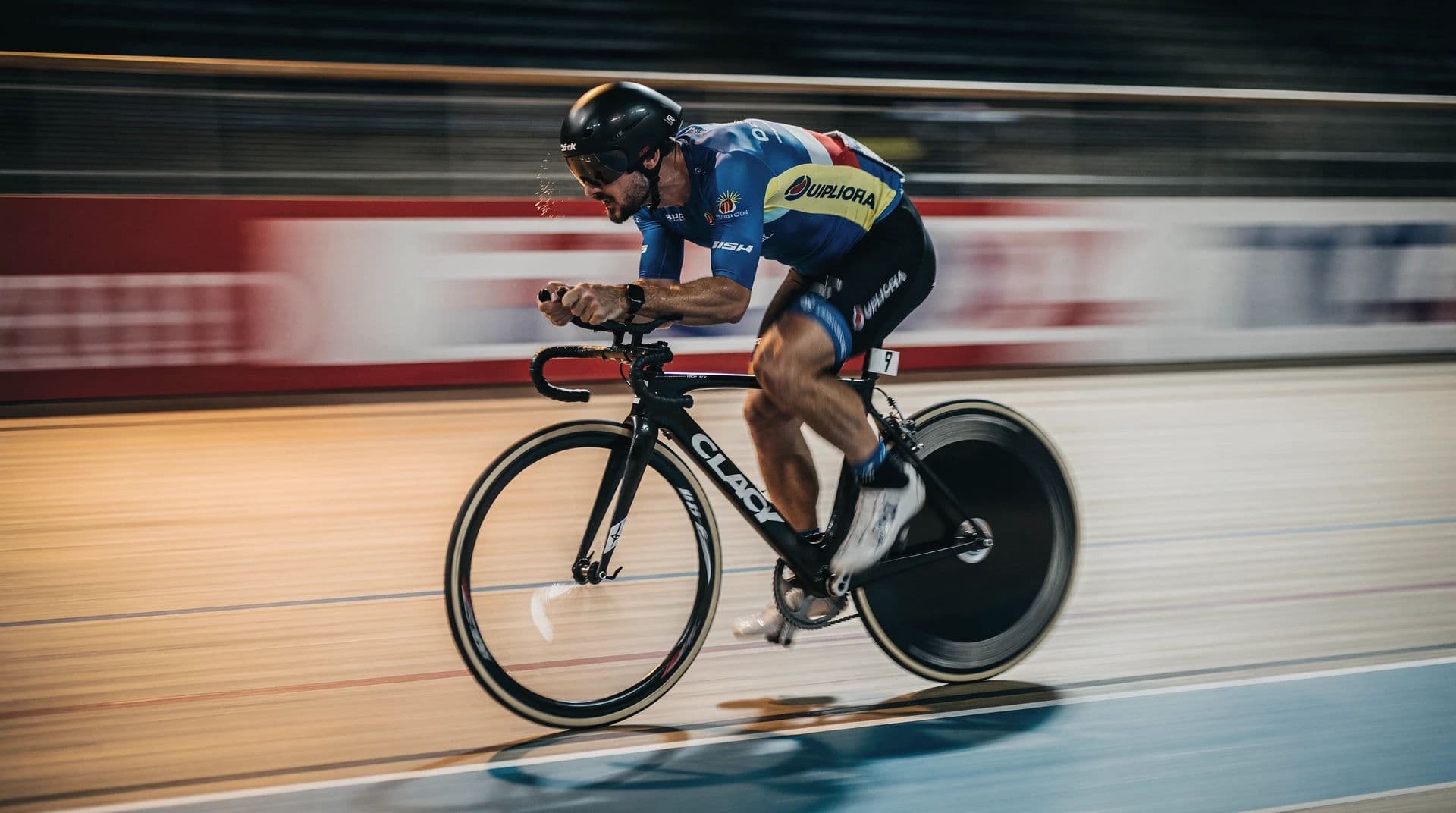 Cyclist sharp against a streaked velodrome background, generated with Flux