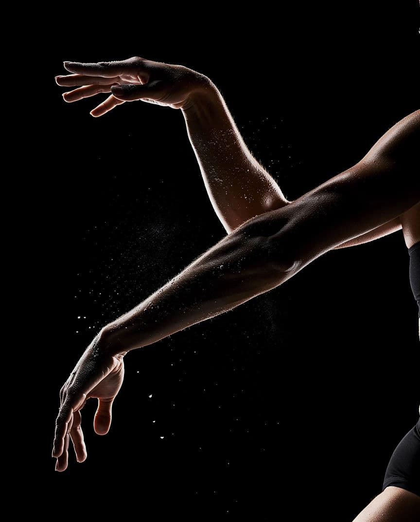 Dancer separated from a black ground by a hard rim light, generated with Flux
