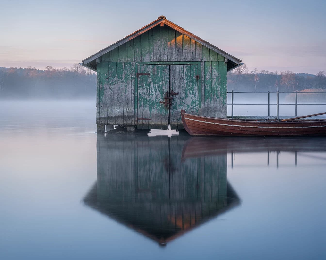 Boathouse mirrored in still water at dawn, generated with Flux