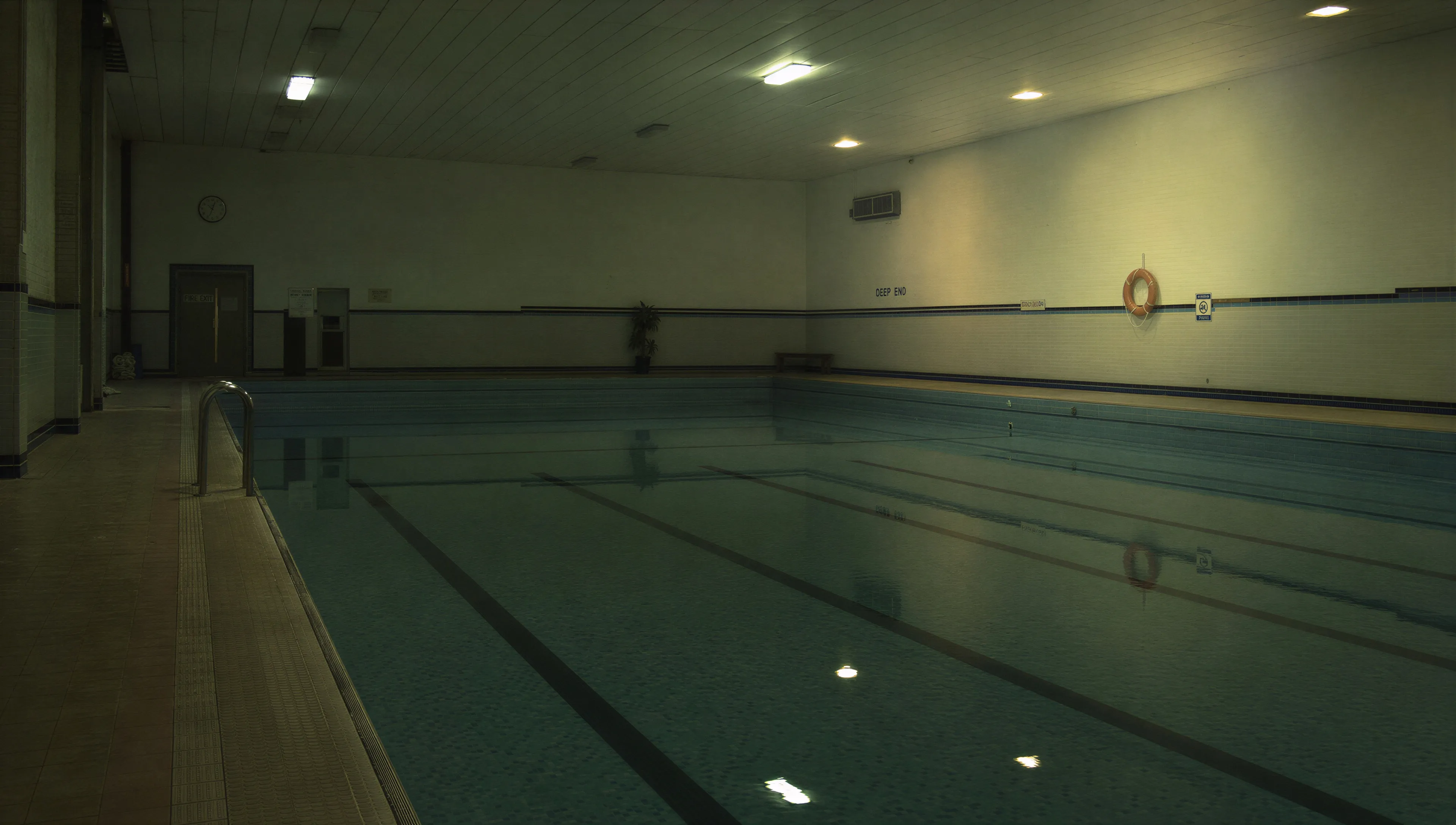 Indoor swimming pool, lights on, empty